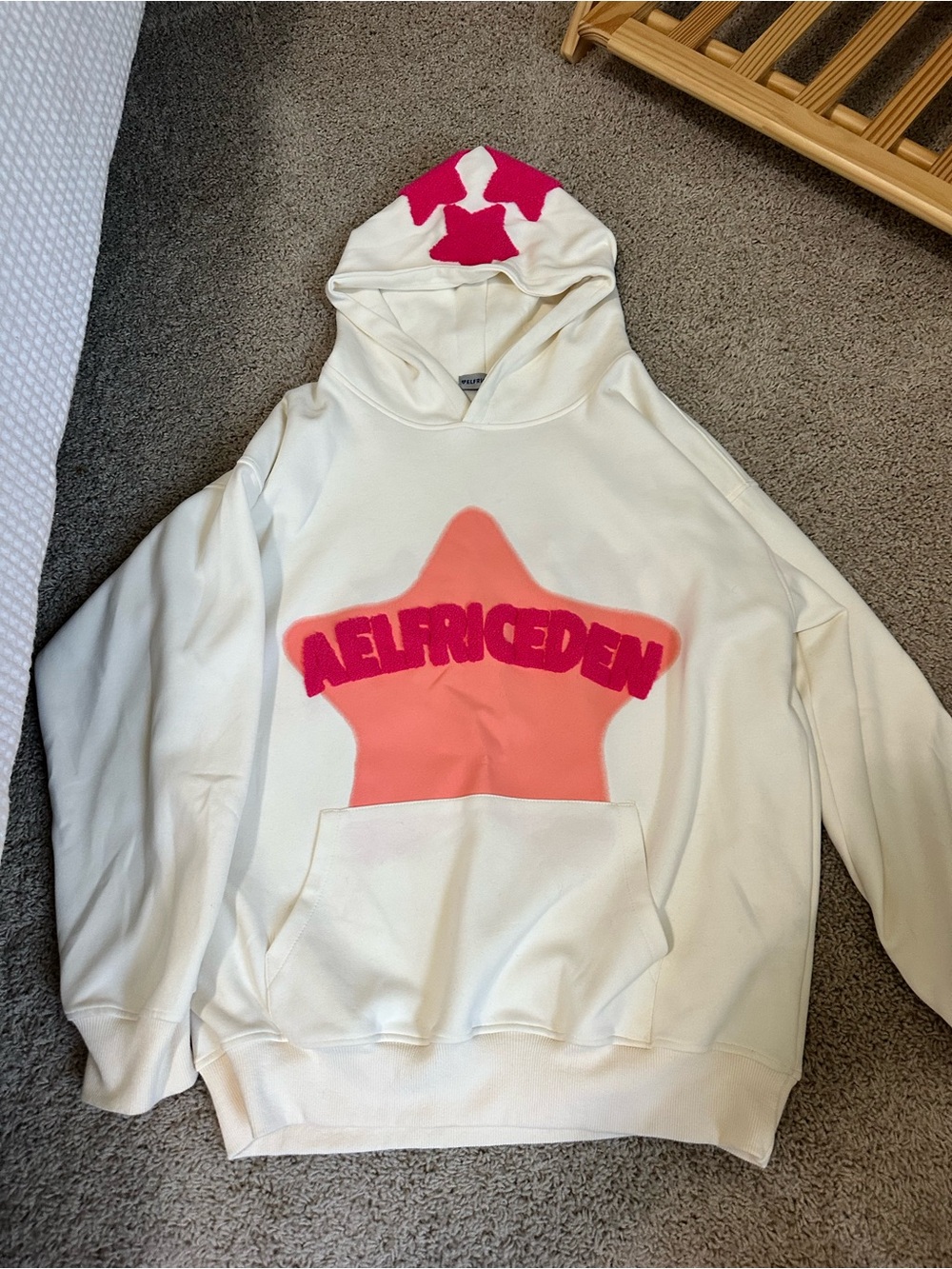 We White Hoodie with Pink Star Logo